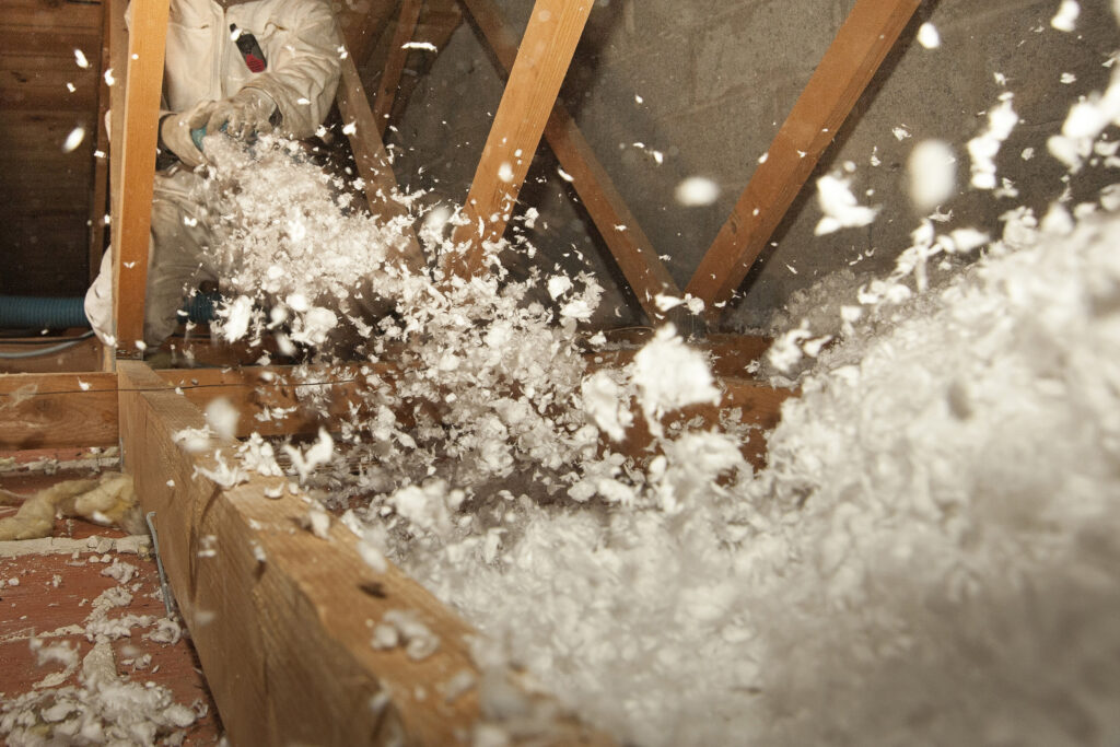 Installer Blowing in Attic Insulation